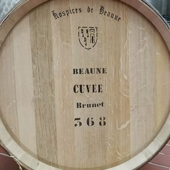 A close-up of a wine barrel from historical wine auction Hospices de Beaune, which Elden Selections participates in every year. The barrel has the words, Hospices de Beaune, Beaune Cuvee Brunet 368 printed on it. burgundywine.com