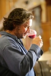 Man sniffing a glass of wine before tasting.