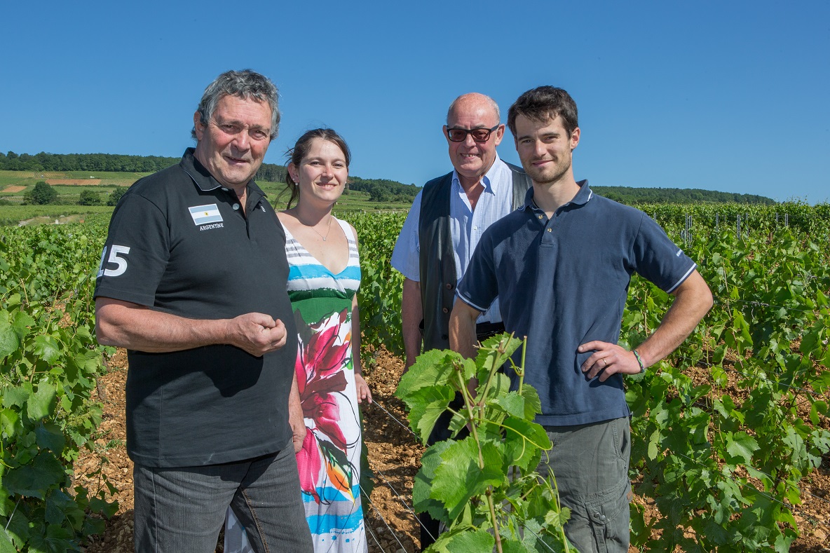 The Capitain Family, standing in the vineyard.