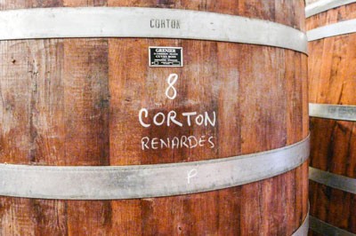 A barrel of Aloxe-Corton wine reading '8 Corton Renardes'
