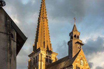 The spires of a historic cathedral in Ladoix, Burgundy, France.