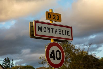 A street sign in front of a dusk sky in Monthelie, Burgundy, France.