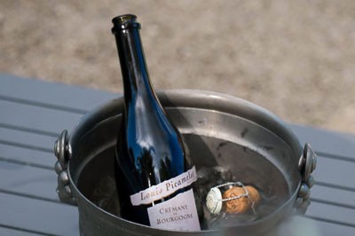 A bottle of Cremant de Bougogne resting in an ice bucket. 