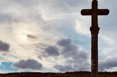 A historic cross sitting in front of vineyards in Vosne-Romanee, Burgundy, France. 